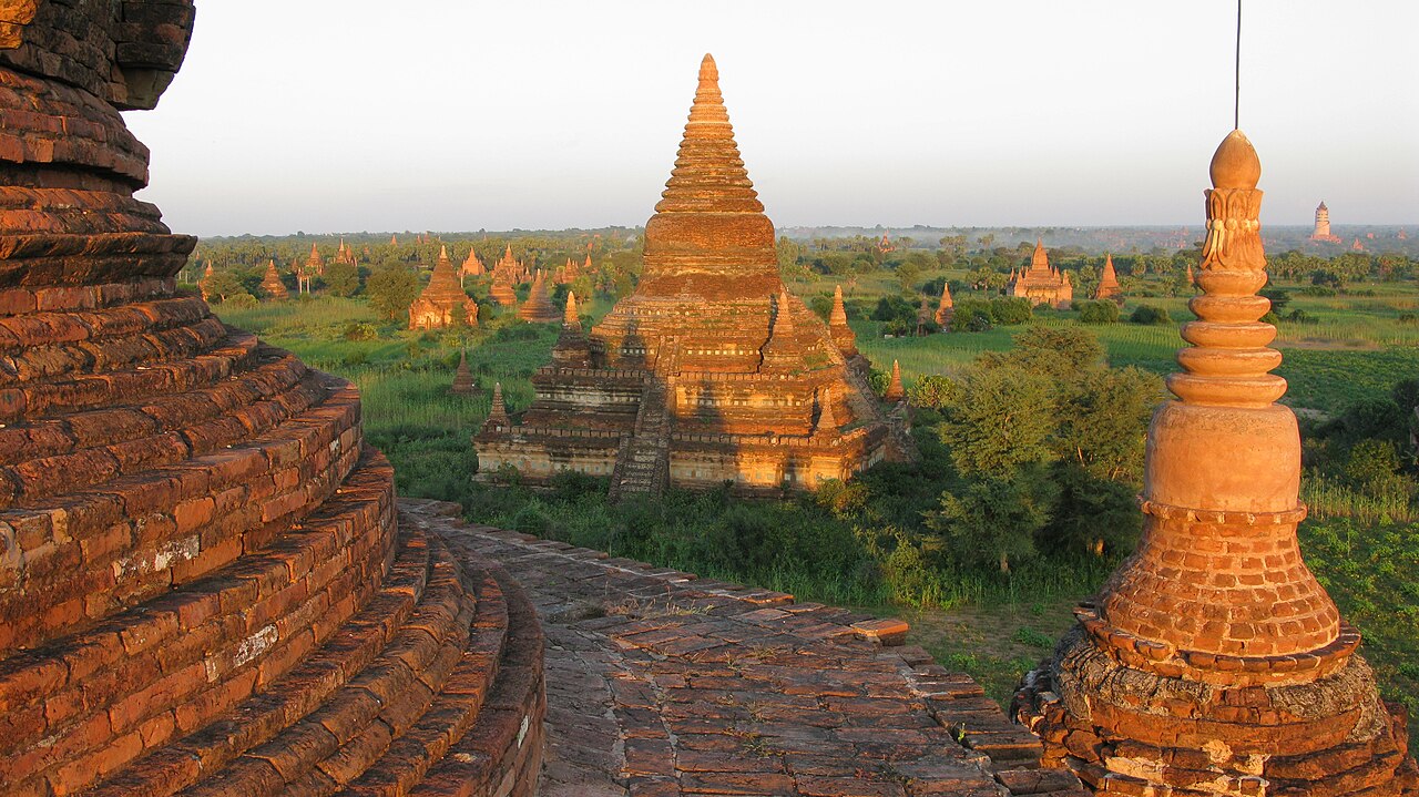 Historic Buddhist temples rising above the green plains of Bagan, Myanmar